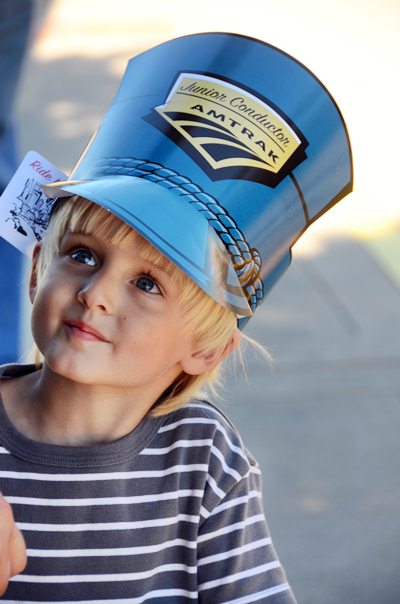 child with Amtrak hat